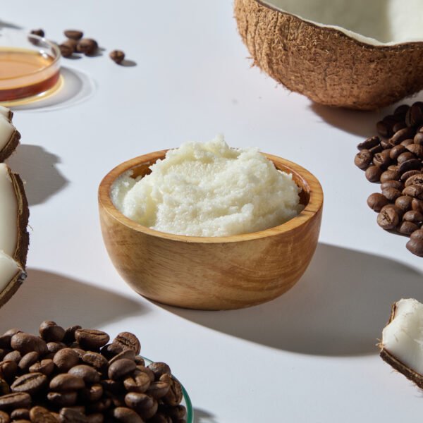 coffee beans on counter and body butter in wooden bowl